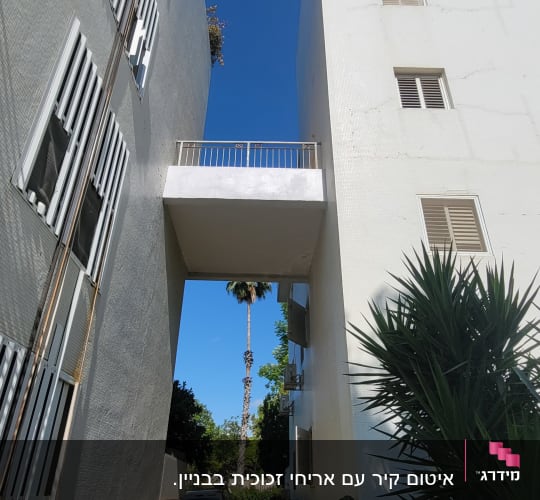 מעבר בין שני בניינים עם מרפסת עליונה